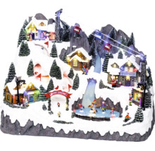 Geanimeerd kerstdorp op besneeuwde berg met kabelbaan, ijsbaan, verlichte huisjes en kerstbomen
