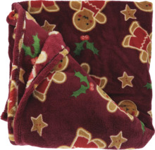 Zachte pluche plaid met kerstmotieven zoals peperkoekmannetjes, sterren en hulst.