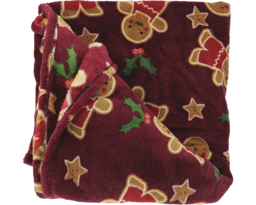 Zachte pluche plaid met kerstmotieven zoals peperkoekmannetjes, sterren en hulst.