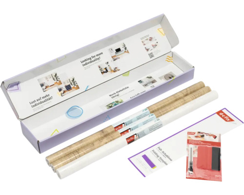 d-c-fix set met twee rollen plakfolie in houtlook, een witte rol, vouwsjabloon, rakel en cutter in een geopende verpakking.
