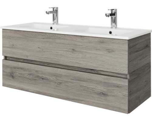 Modern badkamermeubel in eikenlook met dubbele wastafel en twee verchroomde kranen. Voorzien van twee ruime laden.