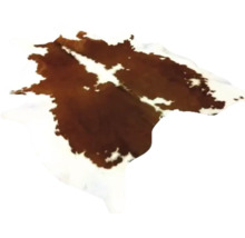 Koeienhuid vloerkleed van natuurlijke huid met bruin-wit vlekkenpatroon.