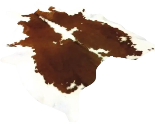 Koeienhuid vloerkleed van natuurlijke huid met bruin-wit vlekkenpatroon.