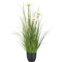Kunstgrasplant met witte bloemen in zwarte pot.