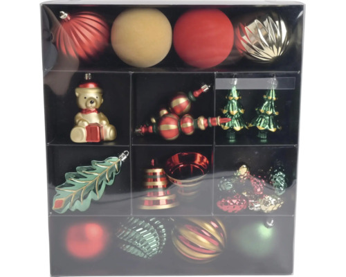 Set met rode, gouden en groene kerstballen en kersthangers zoals een beer, kerstboom, blad en bel in een doos.