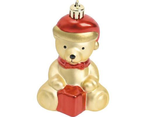 Kerstboomversiering in de vorm van een zittende teddybeer met kerstmuts en cadeau.