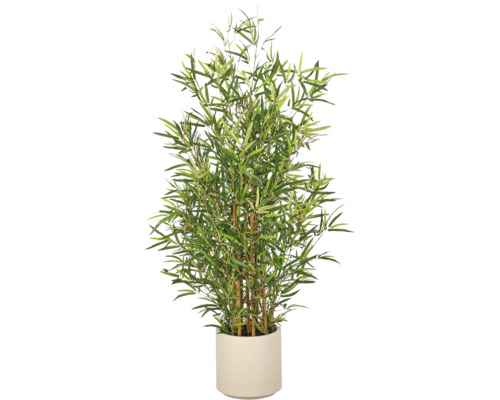 Kunstbamboeplant met groene bladeren en bruine stengels in een lichte cilindrische pot.