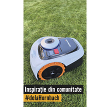 Navimow i105 robotmaaier op een gazon met oranje wielen en bedieningspaneel.