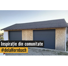 Dubbele garage in aanbouw met OSB-wandplaten, twee antracietkleurige sectionaaldeuren en een donker shinglesdak.