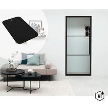 Moderne binnendeur met glas en een zwart frame in een licht ingerichte woonkamer met een bank (Image AI modified or generated)