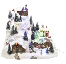 Kerst winterdorp scène met huizen, skiërs en kerstbomen op een besneeuwde heuvel