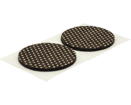 Twee ronde meubelglijders van vilt met noppen op een draagpapier