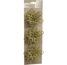 Drie goudkleurige, glitterende bloemdecoraties op een verpakking.