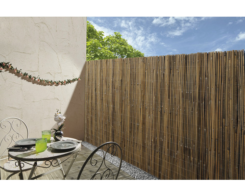 Bamboe privacyscherm op een balkon met tuintafel en decoratie