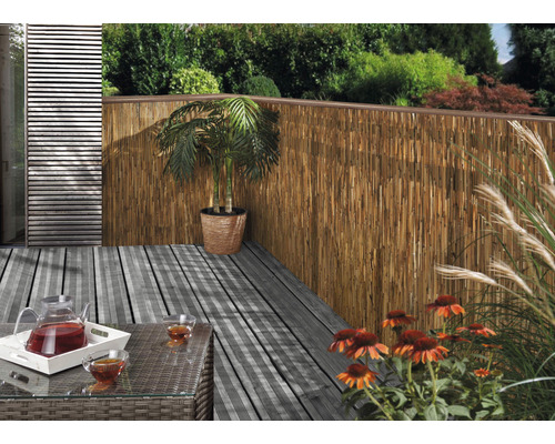 Terras met bamboehek, tafel, drankjes en beplanting