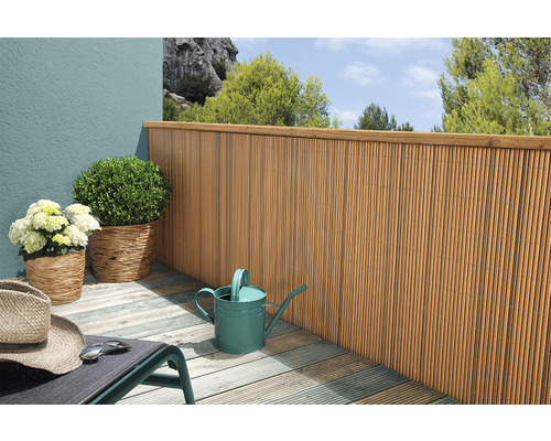 Balkonscène met bamboe schutting, planten en gieter