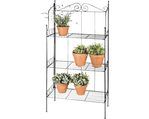 Decoratief metalen plantenrek met drie niveaus en planten in terracotta potten