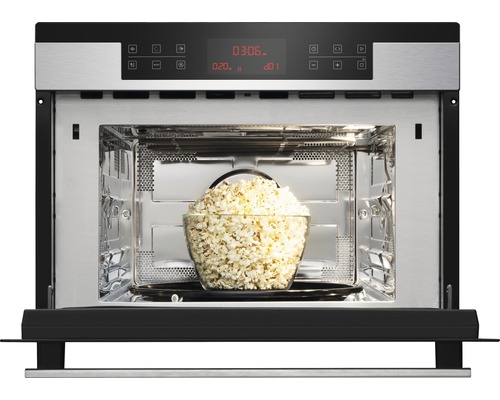 Open magnetron met een kom popcorn erin