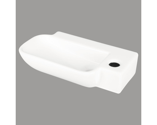 Witte keramische wastafel met kraangat