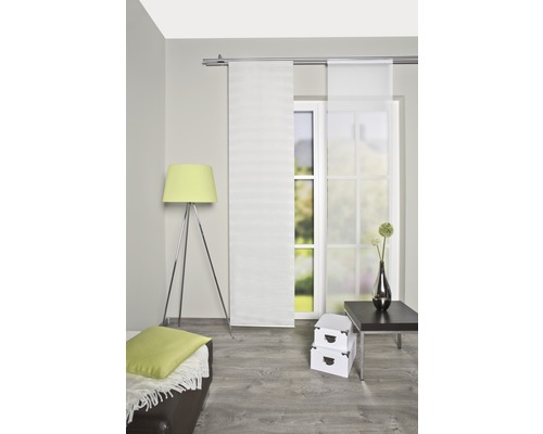 Lichte woonkamer met schuifgordijnen, staande lamp en decoratie