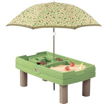 Groene zandtafel met poten en parasol met bladerenpatroon