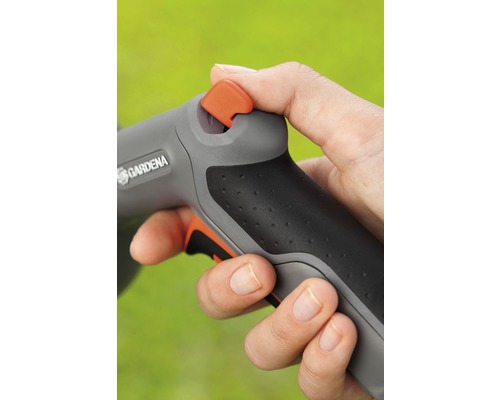 Een hand bedient een Gardena tuinspuit.