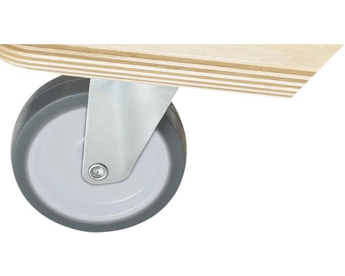 Detail van een zwenkwiel met behuizing op een meubelstuk.