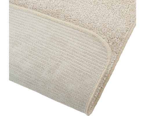 Detailopname van een beige tapijt met antislip achterkant