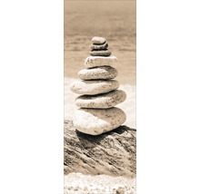Decoratieve stenen toren op een stuk hout aan de oever