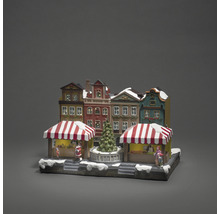 Kerstmarktdorp met huizen, kraampjes en kerstboom als decoratie