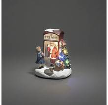 Decoratieve kerstscène met telefooncel, kerstman en meisje