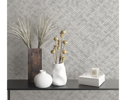 Wanddecoratie met visgraatmotief en decoratieve objecten op een zwarte tafel