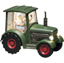 Decoratieve groene tractor met kerstmanfiguur en sneeuw