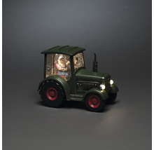 Decoratieve sneeuwbol met kerstman in een tractor