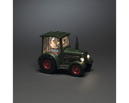 Decoratieve sneeuwbol met kerstman in een tractor