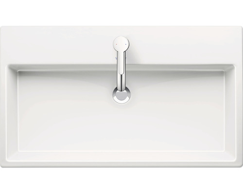 Bovenaanzicht van een witte wastafel met kraan