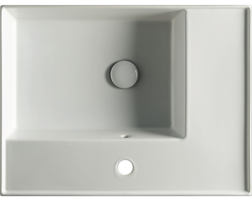 Bovenaanzicht van een wastafel van keramiek met kraanplateau