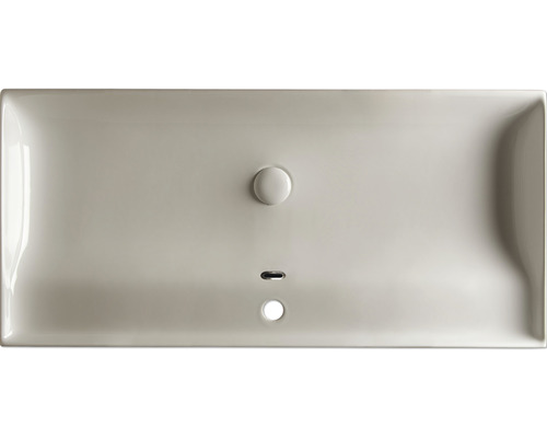 Keramische wastafel van bovenaf gezien met overloop en afvoer