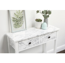 Decoratieve opstelling op een witte consoletafel met lades en marmerfolie