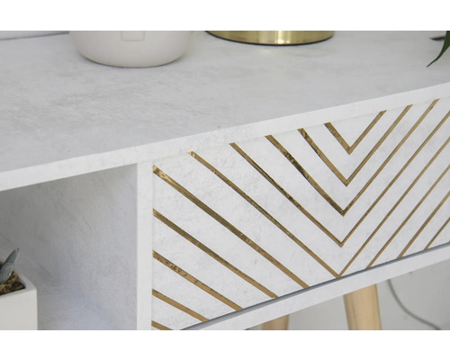 Close-up van een witte tafel met lade en goudkleurig zigzagpatroon