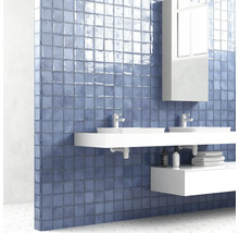 Moderne badkamer met blauwe tegels, dubbele wastafel en spiegelkast