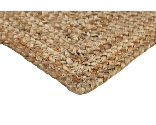 Detailopname van een gevlochten vloerkleed van natuurlijke vezels