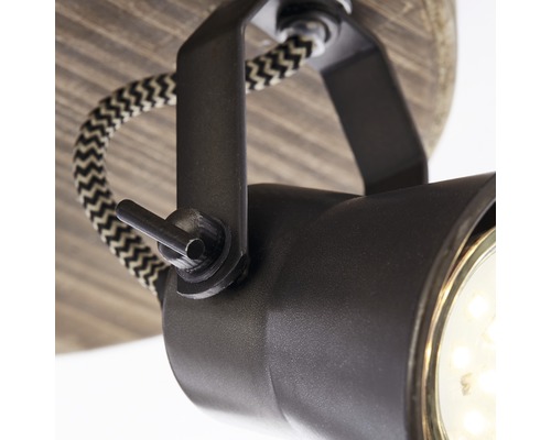 Detailopname van een zwarte plafondlamp met textielkabel