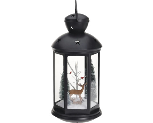 Decoratieve lantaarn met hertenfiguren en bomen voor de kerstperiode