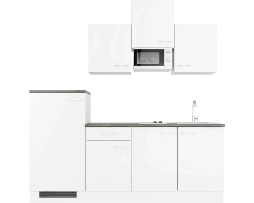 Witte keuken met spoelbak, kookplaat en magnetron