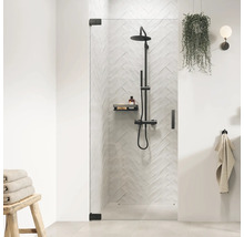 Inloopdouche met douchearmatuur en plank in een moderne badkamer.