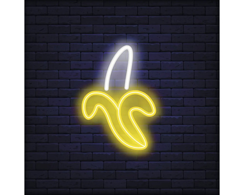 Neonlamp in de vorm van een banaan voor een bakstenen muur