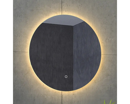 Ronde spiegel met verlichting aan een muur