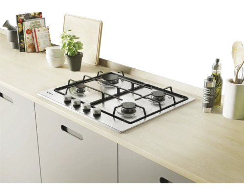 Roestvrijstalen gaskookplaat met vier branders in een lichte keuken.