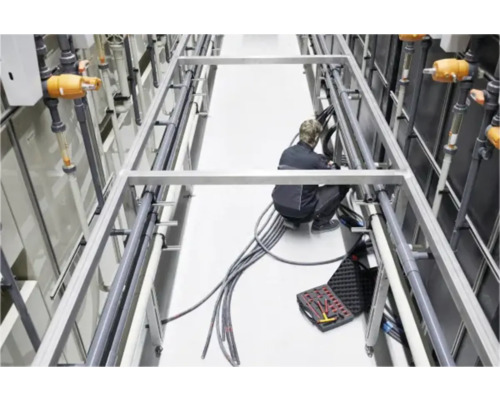 Installatie van een industriële pijpleiding met een persoon en gereedschapskist